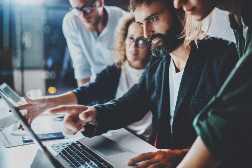 IT workers collaborating at workstation - skilled workers